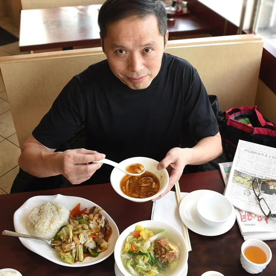 Rice, stir-fried vegetables and soup served at a restaurant table
